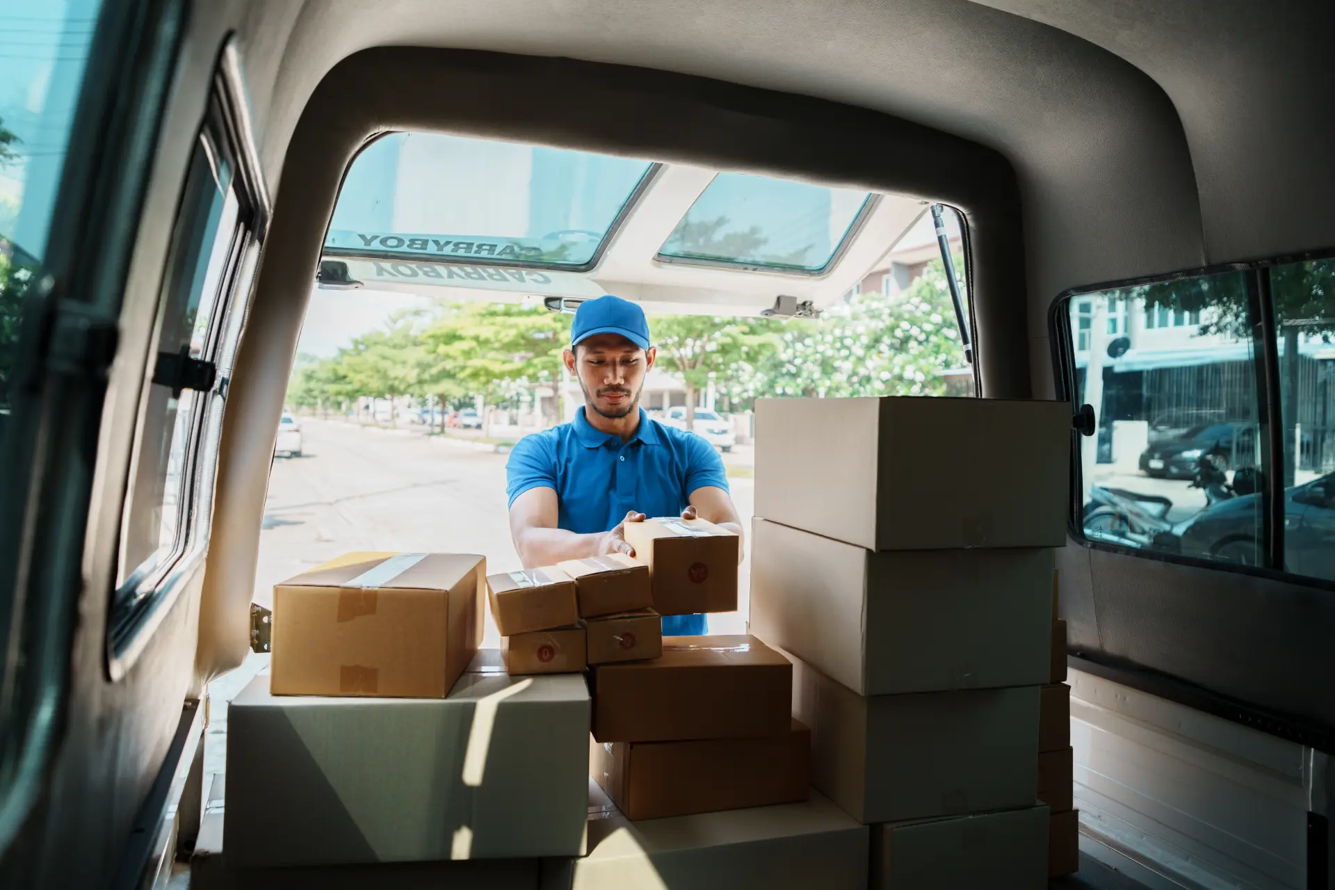 Delivery man organizing parcels