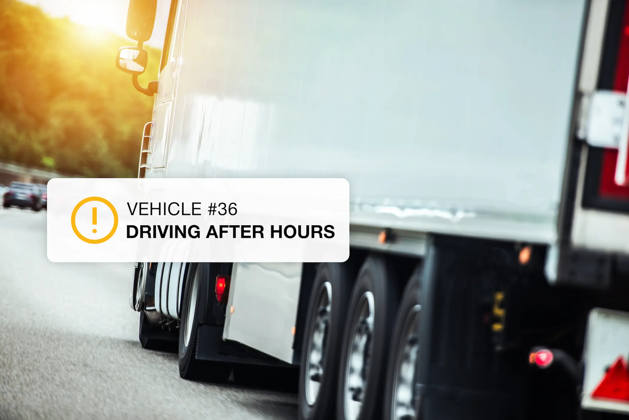 Semi-truck driving on a highway with an after-hours driving alert notification overlay for fleet monitoring
